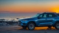 Blue compact SUV car with sport and modern design parked on concrete road by the sea at sunset