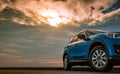 Blue compact SUV car with sport and modern design parked on concrete road by the sea at sunset in the evening. Hybrid and electric Royalty Free Stock Photo