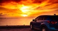 Blue compact SUV car with sport and modern design parked on concrete road by the sea at sunset. Hybrid auto and automotive concept Royalty Free Stock Photo