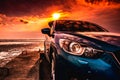 Blue compact SUV car with sport, modern, and luxury design parked on concrete road by the sea at sunset. Front view of beautiful