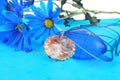 Blue composition with heart pendant. Royalty Free Stock Photo