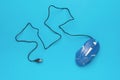 A blue computer mouse with a USB cable on a blue background Royalty Free Stock Photo