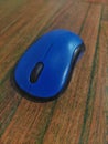 Blue Computer Mouse on Wooden Surface Royalty Free Stock Photo