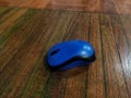 Blue Computer Mouse on Wooden Surface Royalty Free Stock Photo
