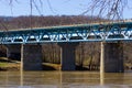 A Blue Concrete and Steel Bridge over a Brown River