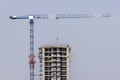 Blue construction crane is building new modern skyscraper. Royalty Free Stock Photo