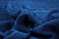 Blue corduroy. Soft folds of fabric. Elegant background with copy space Royalty Free Stock Photo