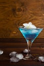 Blue cosmopolitan cocktail on wooden background Royalty Free Stock Photo