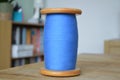 Blue Cotton Bobbin on Display on a Wooden Table