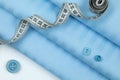 Blue cotton fabric on which the centimetric tape in the form of a spiral Royalty Free Stock Photo