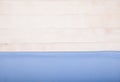 A blue cotton napkin lies flat on a white wooden background. Horizontally. Copy spaes