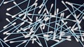 Blue cotton swabs pile on dark background. 3D rendering. Royalty Free Stock Photo