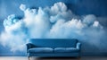 A blue couch is sitting in front of a wall with clouds on it Royalty Free Stock Photo