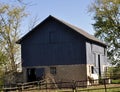 Blue Barn with White horse on the side - in the country. Royalty Free Stock Photo