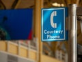 Blue courtesy phone sign hanging high at an airport Royalty Free Stock Photo