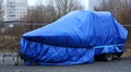 Blue-covered boat in the Parking lot