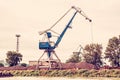 Blue crane in cargo port, red filter Royalty Free Stock Photo