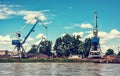 Blue cranes in cargo port, Danube river, retro photo filter Royalty Free Stock Photo
