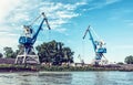 Blue cranes in cargo port, Danube river