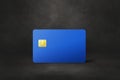 Blue credit card on a black concrete background Royalty Free Stock Photo