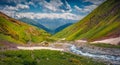 Blue creek flowing in Caucasus mountains.