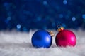 Blue and crimson Christmas balls on white fur with garland light Royalty Free Stock Photo