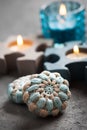 Blue crochet stones and lit candles