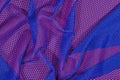 Blue crumpled nonwoven fabric on a red Royalty Free Stock Photo