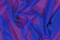 Blue crumpled nonwoven fabric on a red Royalty Free Stock Photo