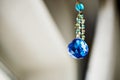 Blue crystal Feng Shui hanging on a string of beads Royalty Free Stock Photo