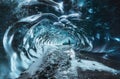 Blue crystal ice cave entrance with tourist climber and an underground river beneath the glacier located in the Royalty Free Stock Photo