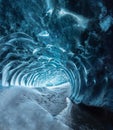 Blue crystal ice cave entrance and an underground river beneath the glacier located in the Highlands in Iceland Royalty Free Stock Photo