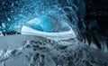 Blue crystal ice cave entrance and an underground river beneath the glacier located in the Highlands in Iceland Royalty Free Stock Photo