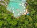 Blue crystal water in paradise Bay with boats on the wooden pier at Kayangan Lake in Coron island, Palawan, Philippines Royalty Free Stock Photo