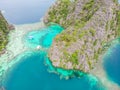 Blue crystal water in paradise Bay with boats on the wooden pier at Kayangan Lake in Coron island, Palawan, Philippines Royalty Free Stock Photo