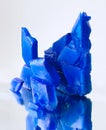 Blue crystals of copper sulfate on mirror surface