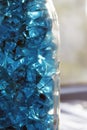 Blue crystals of glass with highlights of light on them, blur, close-up, abstraction