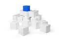 Blue cube on top of heap of white cubes over white background - software module, teamwork or standing out from the crowd Royalty Free Stock Photo