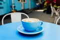 Blue cup of aromatic coffee on a blue table. Royalty Free Stock Photo