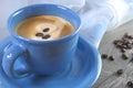 A blue cup with coffee perfect for breakfast.