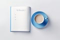 Blue cup of coffee and to do list notebook