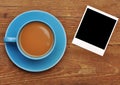 Blue cup of hot coffee and old paper photo frame Royalty Free Stock Photo