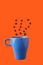 Blue cup with steam of coffee beans on an orange background with a copy space. vertical orientation