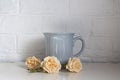 Blue cup on a table with white roses near Royalty Free Stock Photo