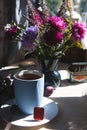 A cup of tea with bouquet of aster flowers, morning tea concept