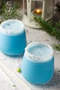 Blue curacao Christmas Cocktail on Christmas decorated holiday table Royalty Free Stock Photo
