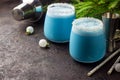 Blue curacao Christmas Cocktail, garnished with coconut on Christmas decorated holiday table with Christmas ornaments. Holiday Royalty Free Stock Photo