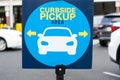 Blue curbside pickup sign with a picture Royalty Free Stock Photo