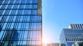 Blue curtain wall made of toned glass and steel constructions under blue sky. A fragment of a building. Royalty Free Stock Photo