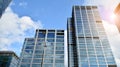 Blue curtain wall made of toned glass and steel constructions under blue sky. A fragment of a building. Royalty Free Stock Photo